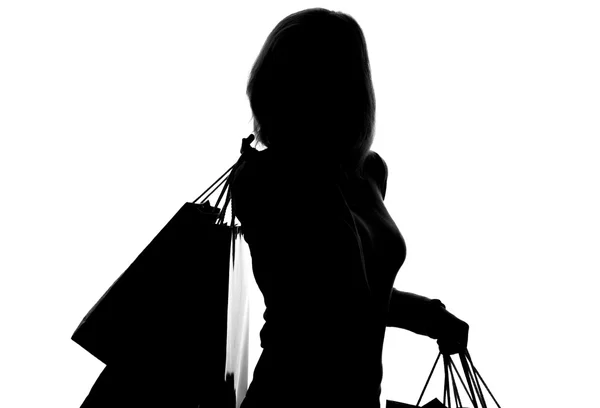 Silhouette di donna con shopping bag — Foto Stock