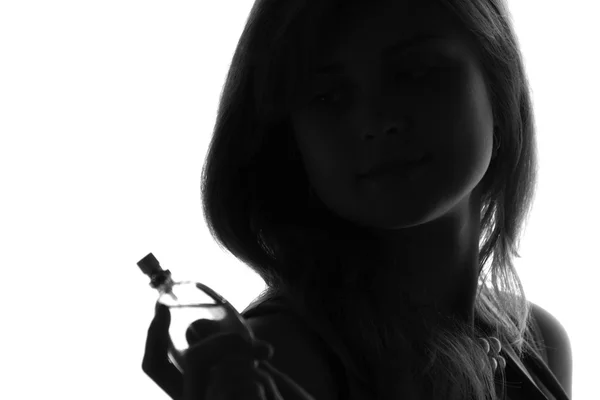 Portrait of a young woman with bottle of perfume — Stock Photo, Image