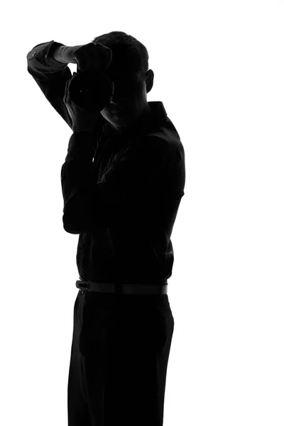 Silhouette of a man with a camera in hand — Stock Photo, Image