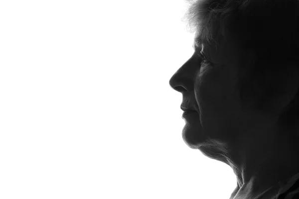 Silhouette of an old sad woman — Stock Photo, Image