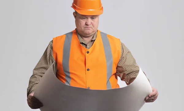 Onstruction Worker Hard Hat Looking Opened Paper Project Hands Grey — Stock fotografie