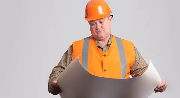 Onstruction Worker Hard Hat Looking Opened Paper Project Hands Grey — Fotografia de Stock