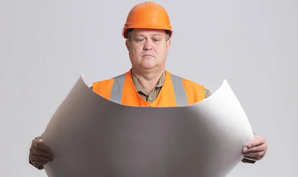 Onstruction Worker Hard Hat Looking Opened Paper Project Hands Grey — Stock fotografie