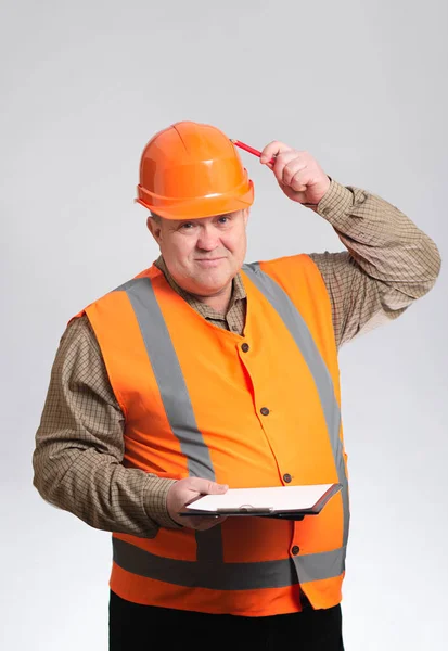 Humorous Construction Worker Scratches Pencil Head Hard Hat Viewing Documents — Stock Photo, Image