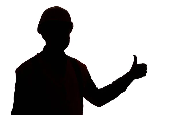 若いです建設労働者シルエットでハード帽子ショー親指アップクラスのサイン上の白い隔離されたスタジオの背景 — ストック写真
