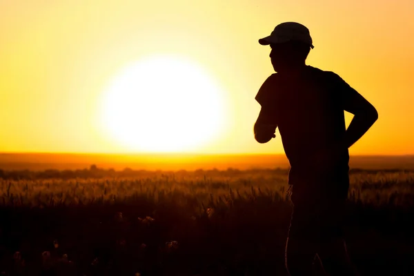 Un giovane che corre sul campo — Foto Stock