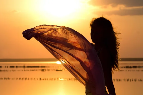 Silhouette of a young girl with a shawl — Stock Photo, Image