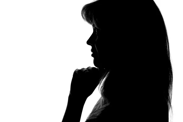 Silhouet van een peinzende vrouw op een witte achtergrond — Stockfoto