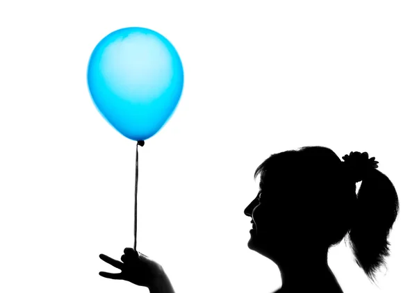 Silhouette of a cute young girl with blue balloon — Stock Photo, Image