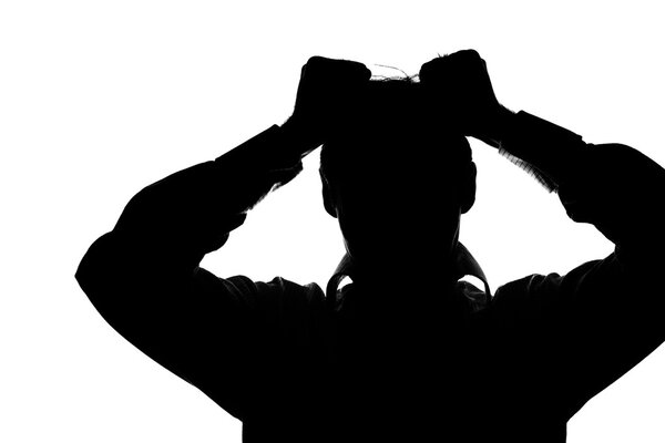 A young man with grief tearing at her hair with both hands