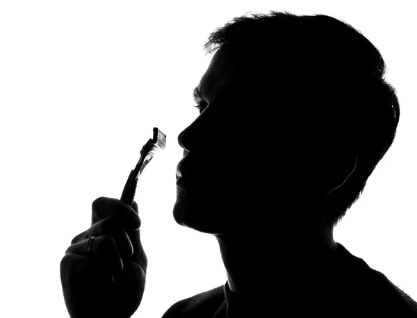 Mladý muž holení - silueta — Stock fotografie