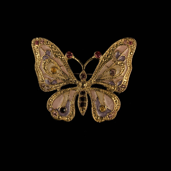 gold vintage brooch with crystals in the shape of a butterfly