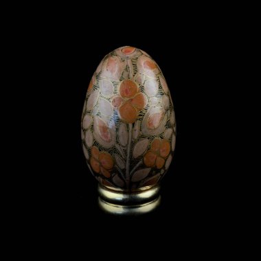 wooden Easter egg with floral patterns on isolated black background