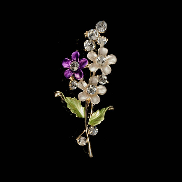 gold antique brooch with precious stones and crystals in the shape of a flower. Vintage brooch in the shape of a flower