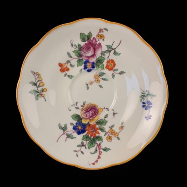 antique plate with a picture of flowers. vintage plate with painting on black isolated background