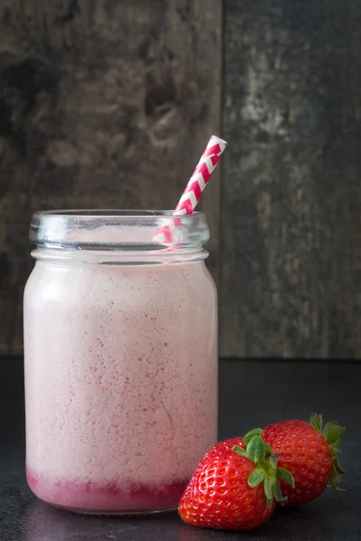 Delicious strawberry smoothie in jar on wood — Stock Photo, Image