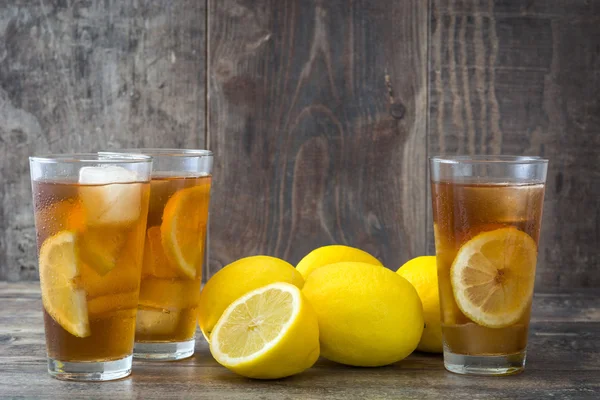 Refreshing iced tea with lemon on wood Stock Image