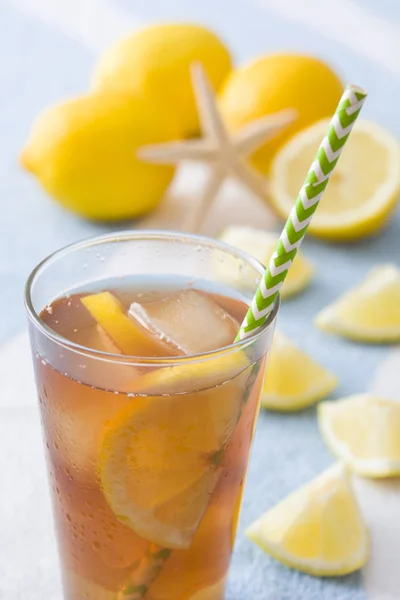 Ice tea with lemon on a beach towel — Stock Photo, Image
