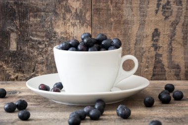 Ahşap üzerine bir bardak yaban mersini