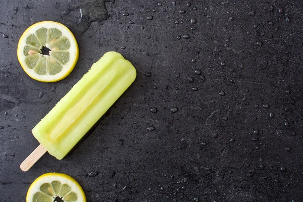 Ghiacciolo al limone su pietra nera — Foto Stock