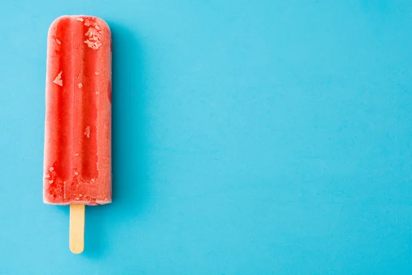 Strawberry popsicle. Blue background