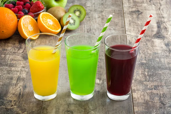 Fresh fruit smoothies on a rustic wooden table — Stock Photo, Image