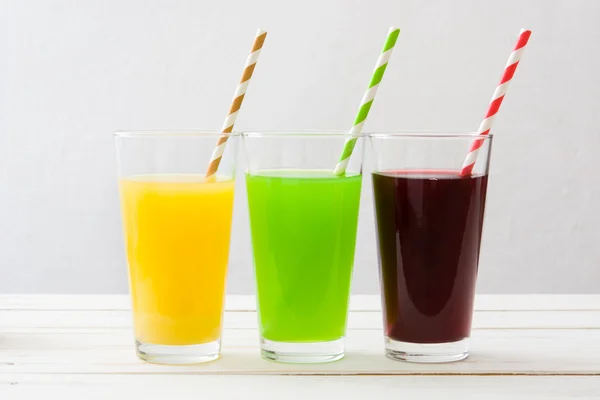 Fresh fruit smoothies on a white wooden table — Stock Photo, Image