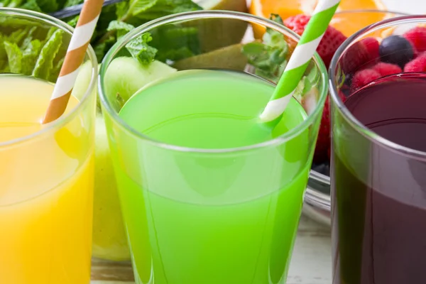 Fresh fruit smoothies on a white wooden table — Stock Photo, Image