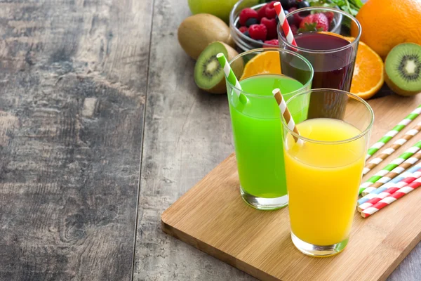 Fresh fruit smoothies on a rustic wooden table — Stock Photo, Image
