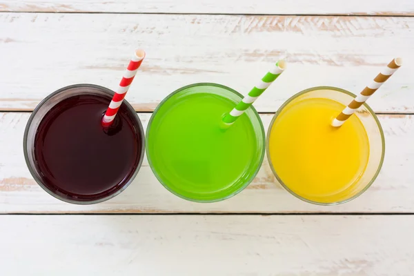 Fresh fruit smoothies on a white wooden table — Stock Photo, Image