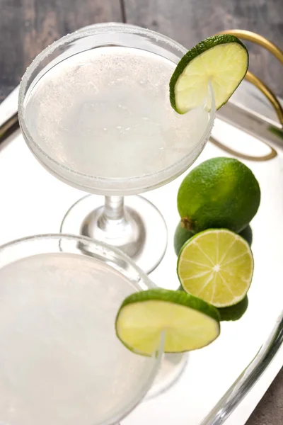 Margarita cocktail on a silver tray and rustic wooden background — Stock Photo, Image