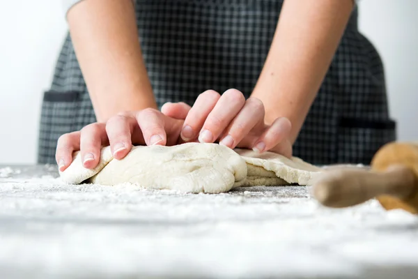 Woman making bread with her hand on wood table — Stock Photo, Image