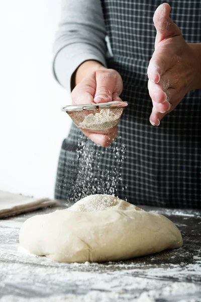 woman kneading bread dough with her hands