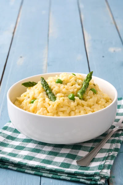 Risotto with vegetables on blue wooden table — Stock Photo, Image