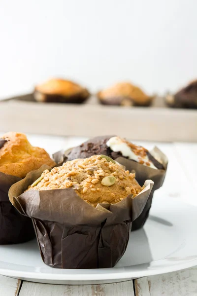 Delicious muffins on a white wooden table — Stock Photo, Image