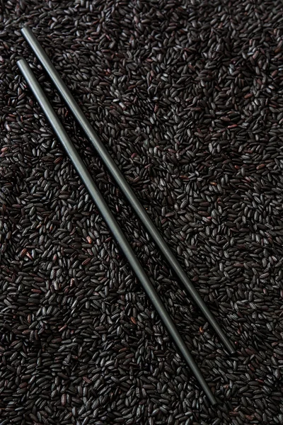 Black rice and chopsticks — Stock Photo, Image