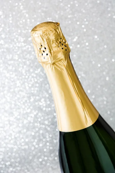 Champagne bottle on brilliant silver background — Stock Photo, Image