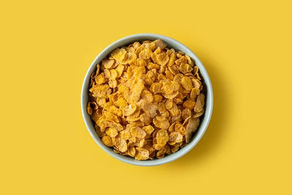 Corn Flakes Blue Bowl Yellow Background Top View — Stock Photo, Image
