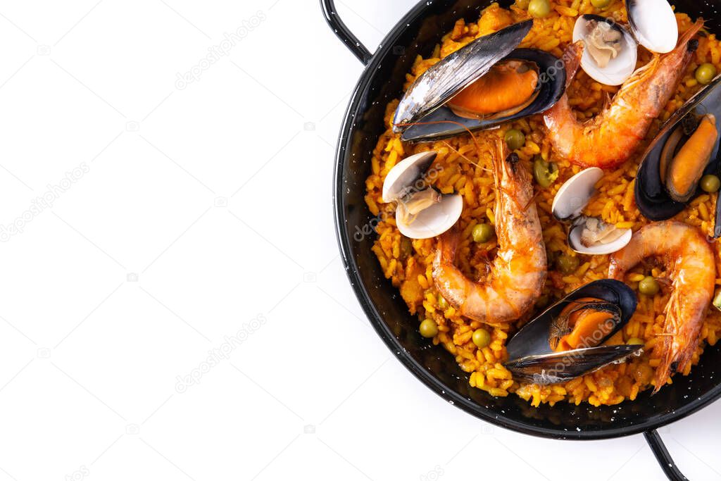 Traditional spanish seafood paella isolated on white background. Top view. Copy space