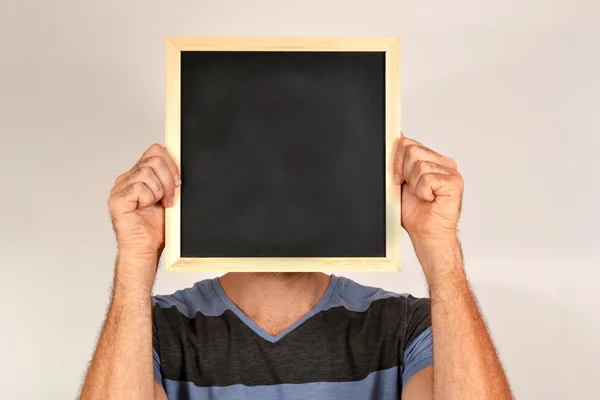 Man med leende ansikte i blackboard — Stockfoto