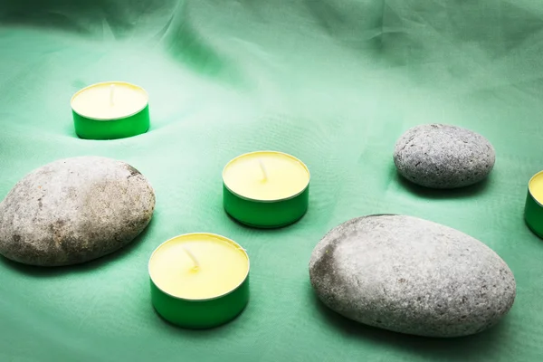 Candles, zen stones and towel on wood — Stock Photo, Image