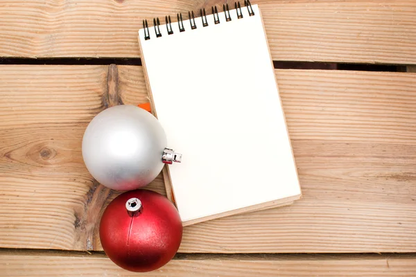 Notebook and Christmas balls — Stock Photo, Image