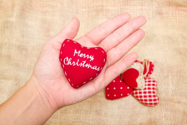 Weihnachtsherz in der Hand — Stockfoto