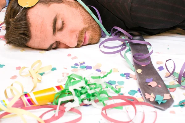 Young man sleeping after a party — Stock Photo, Image