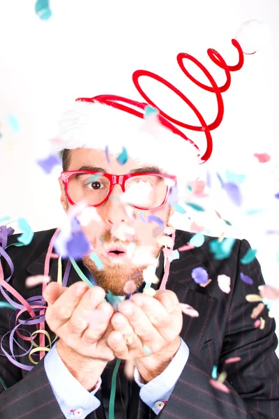 Young man blowing confetti — Stock Photo, Image