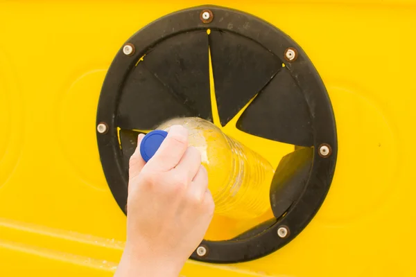 Throwing a bottle into the recycling container — Stock Photo, Image