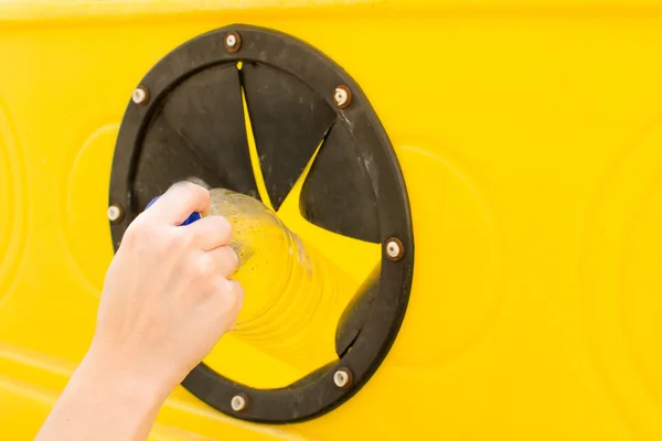 Throwing a bottle into the recycling container — Stock Photo, Image