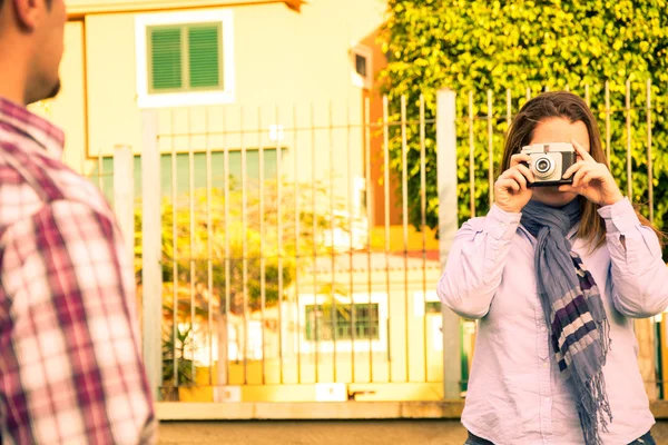 Mujer joven haciendo una foto a su novio en el parque — Foto de Stock