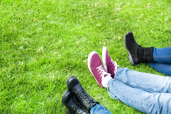 Three shoes on grass — Stock Photo, Image