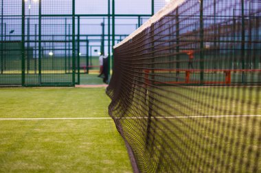 Paddle tennis net at night